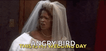 a woman in a wedding dress and veil is saying `` angry bird '' .