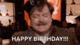 a man with a mustache is wearing a party hat and saying `` happy birthday !!! '' .