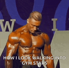 a muscular man is standing in front of a sign and says `` how i look walking into gym stars '' .