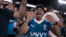 a man in a blue shirt that says savvy