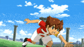 a boy in a red and white soccer uniform is running in front of a tv screen that says tokyo