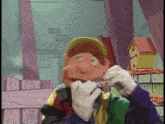 a cartoon character is wearing gloves and a hat and eating a piece of meat .