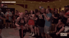 a woman with pink hair and tattoos is wearing a black bra