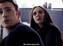 a man and a woman are standing next to each other and the woman says " we talked about this "