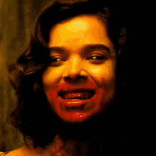 a poster of a woman with blood on her face and the words denims factory below her