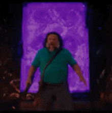 a man is standing in front of a purple wall .