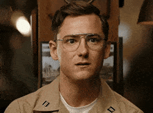 a man wearing glasses and a military uniform is making a surprised face