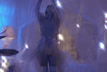 a woman in a costume with pearls around her waist is dancing