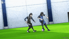 two soccer players are playing a game of soccer on a field