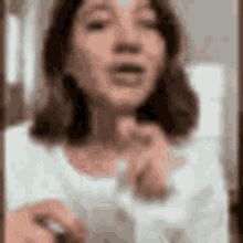 a blurry picture of a woman taking a selfie with her phone .