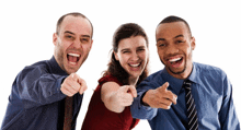 a man and two women are pointing at the camera and smiling
