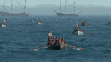 a group of people rowing boats in the water