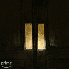 a woman in a blue shirt is running through a doorway with an amazon prime arrow in the corner