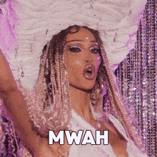 a woman with braids is wearing a white hat and the word mwah is above her