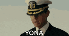 a man in a military uniform salutes in front of a yona logo
