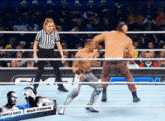 a wrestling match between carmelo hayes and braun strowman is underway