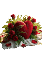 a heart shaped pillow is surrounded by roses and leaves