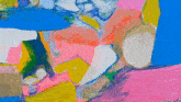 a close up of a colorful painting with pink yellow and blue