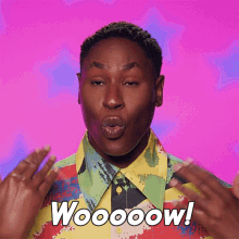 a man in a colorful shirt is blowing a kiss and the words woooow are on the bottom