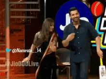 a man and a woman are dancing in front of a jd logo