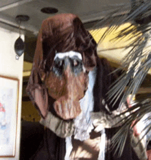 a statue of a monkey is hanging from a ceiling