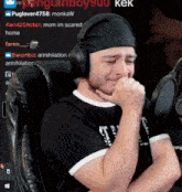a man wearing headphones is sitting in front of a microphone with penguinboy900 written in the corner