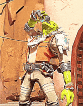 a cartoon character with green arms and legs is standing in front of a brick wall