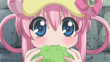 a girl with pink hair and blue eyes is holding a green cabbage