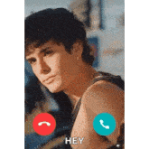 a man is talking on a cell phone while looking at the camera .