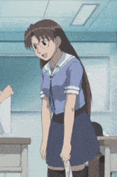 a girl in a school uniform and glasses is standing in a classroom holding a piece of paper .