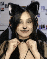 a woman wearing cat ears and a black choker looks at the camera