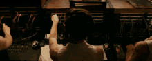 a woman with a tattoo on her arm is working on a machine with the number 9999 on it