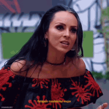a woman wearing a red and black off the shoulder top says relajate muchisimo mujer
