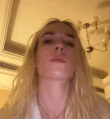 a close up of a woman 's face with long blonde hair