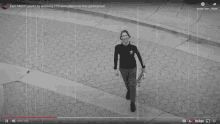 a video of a man walking down a sidewalk with the words earn faceit points by watching ecs and redeem for free gaming