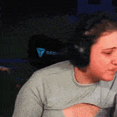 a woman wearing headphones and a shirt that says seo on the back