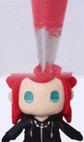 a stuffed toy with red hair and blue eyes has a zipper on the jacket