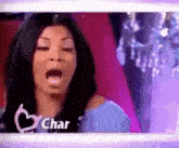 a woman is making a funny face with her mouth open and the word char is on the bottom .