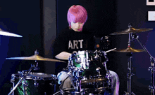 a man with purple hair is playing drums in front of a marshall amplifier