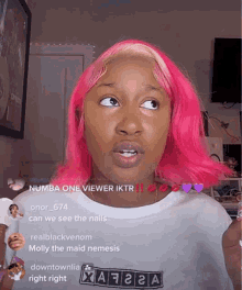 a woman with pink hair is wearing a white shirt that says downtownlia on it