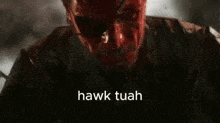a close up of a man with blood on his face and the words `` hawk tuah '' written on it .