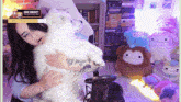 a woman is holding a white dog with a holy energy sign above her head