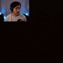 a man wearing headphones is standing in front of a screen that says five nights at freddy 's created cast