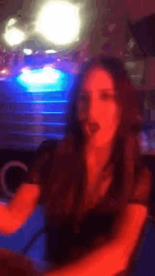 a blurry picture of a woman in a dark room with the letter c in the corner