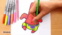 a person is drawing patrick star from spongebob squarepants with a green pencil