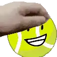 a hand is putting a hat on a tennis ball with a smiley face .