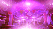 a girl is dancing in a room with purple lights