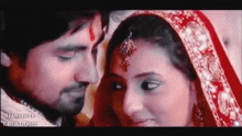 a man and a woman are looking at each other in a close up .