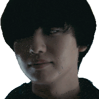 a close up of a young man 's face with a serious look on his face