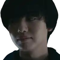 a close up of a young man 's face with a serious look on his face